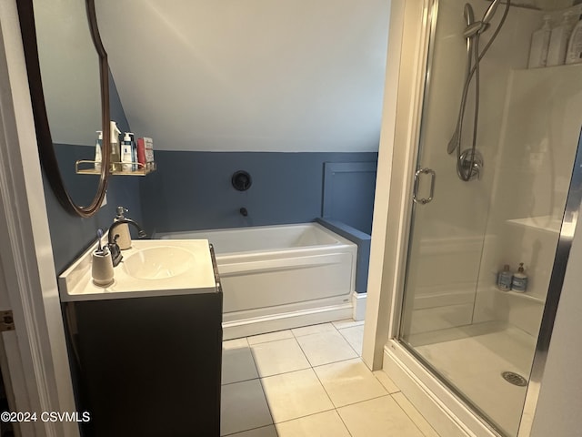 bathroom with tile patterned floors, separate shower and tub, vanity, and lofted ceiling