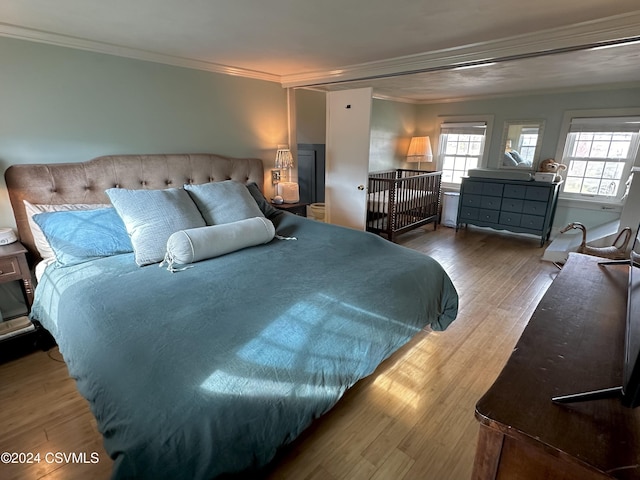 bedroom featuring hardwood / wood-style flooring and ornamental molding