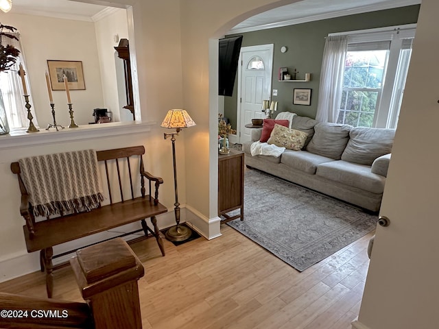 interior space with wood-type flooring and crown molding