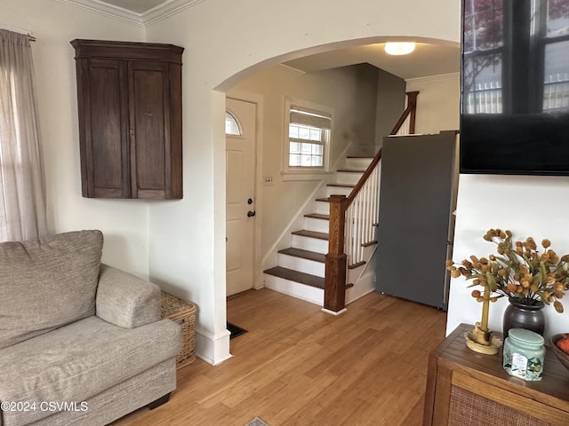 entrance foyer featuring light hardwood / wood-style flooring and ornamental molding