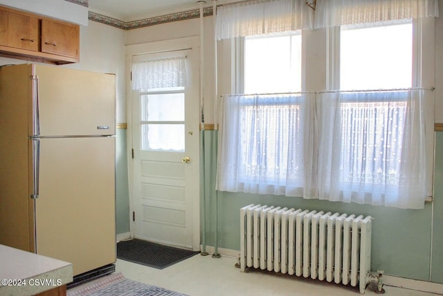 doorway featuring radiator and a healthy amount of sunlight