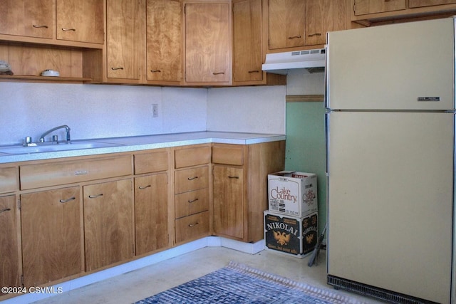 kitchen featuring white refrigerator and sink