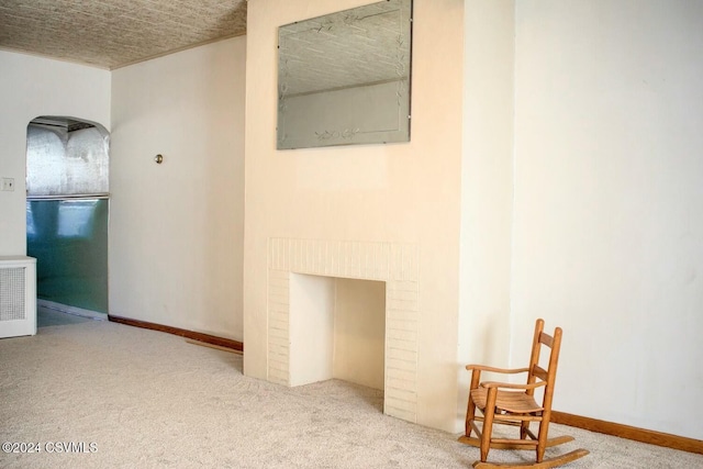 hallway featuring carpet floors and a textured ceiling