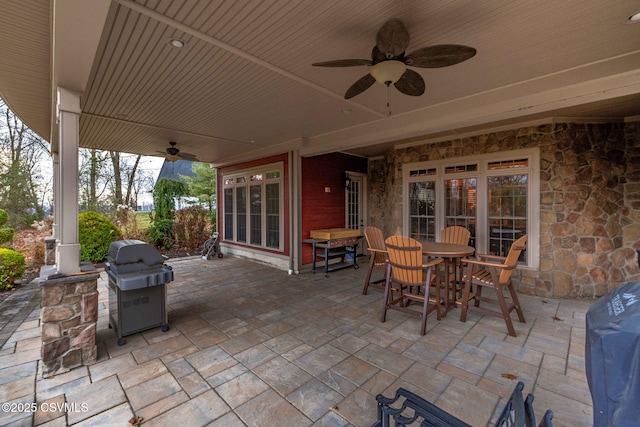 view of patio / terrace featuring outdoor dining space, grilling area, and ceiling fan