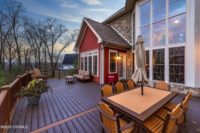 wooden terrace featuring outdoor dining space