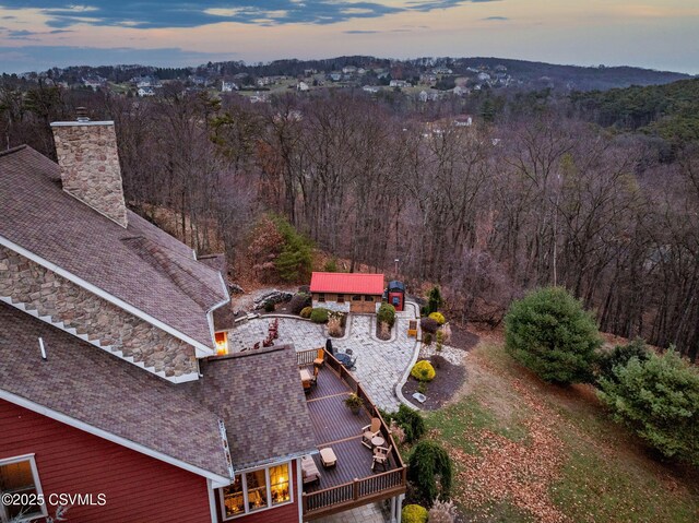 aerial view at dusk with a view of trees
