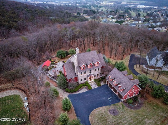 drone / aerial view featuring a view of trees