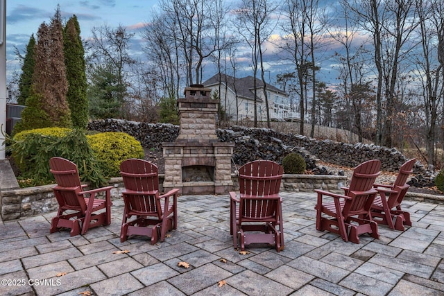 view of patio / terrace featuring an outdoor stone fireplace