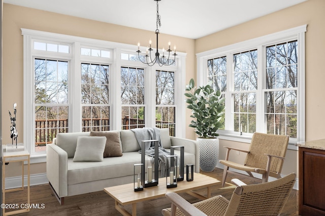 sunroom / solarium with a notable chandelier