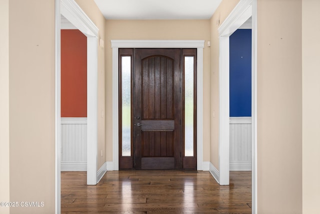 entrance foyer featuring wood-type flooring and a wainscoted wall