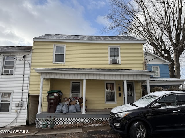 view of front of home featuring cooling unit and covered porch