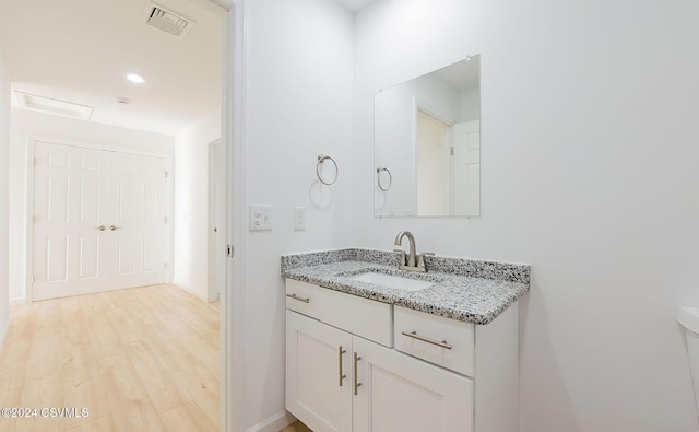 bathroom with hardwood / wood-style floors and vanity