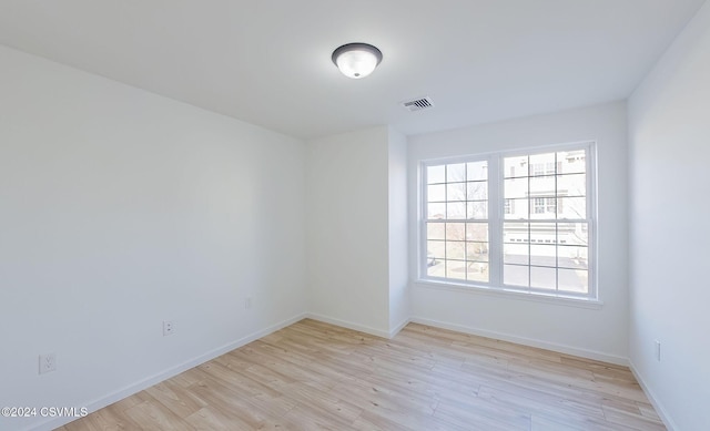 spare room with light hardwood / wood-style flooring