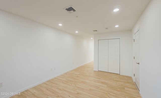 unfurnished bedroom featuring a closet and light hardwood / wood-style floors