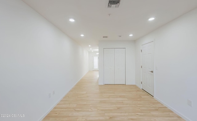 corridor with light wood-type flooring