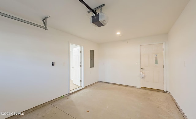 garage with electric panel and a garage door opener