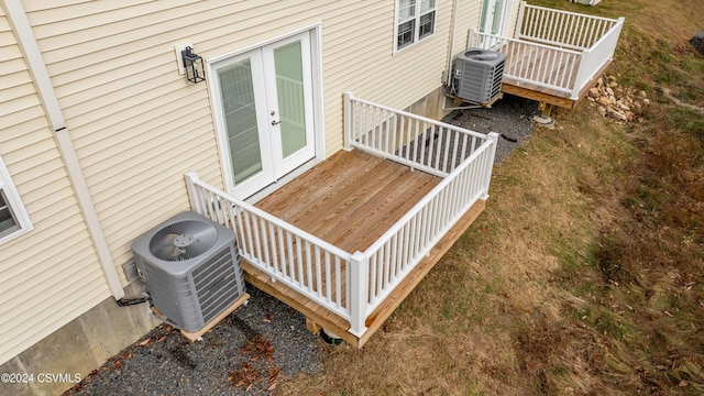 wooden deck featuring cooling unit