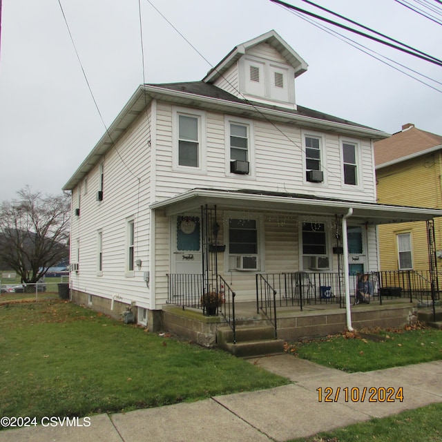 view of front of home featuring covered porch and a front yard