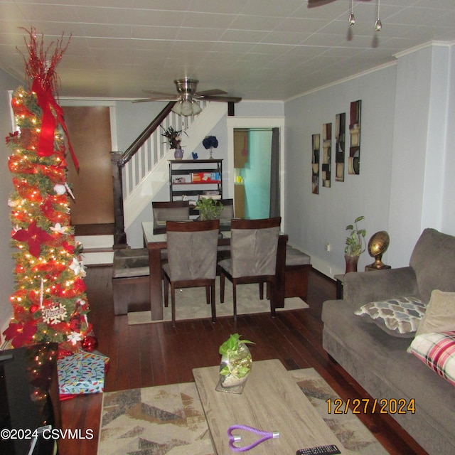 living room with hardwood / wood-style floors, ceiling fan, and crown molding