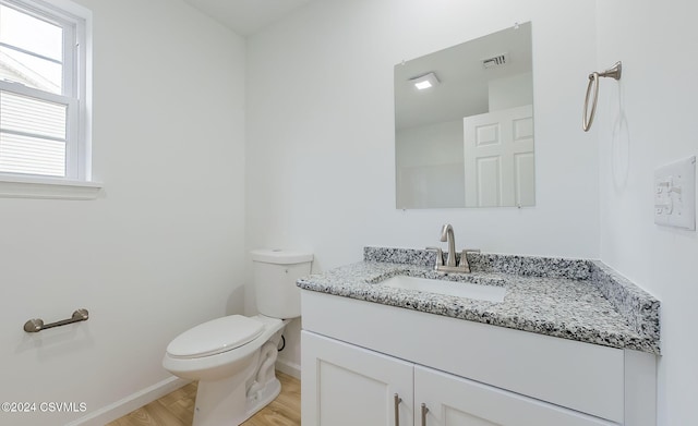 bathroom featuring hardwood / wood-style flooring, vanity, and toilet