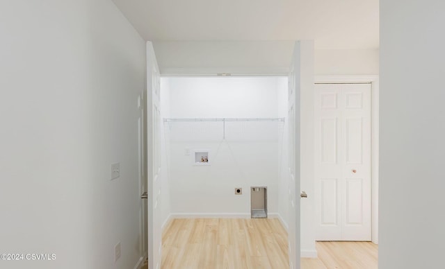 washroom with hookup for an electric dryer, hookup for a washing machine, and light wood-type flooring