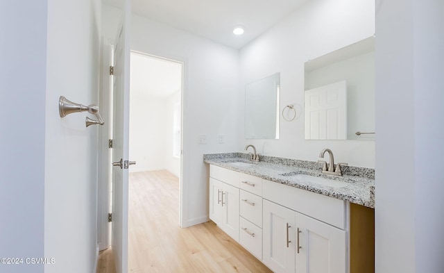 bathroom with vanity and hardwood / wood-style flooring