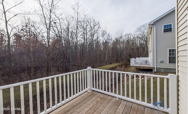 wooden terrace featuring a yard