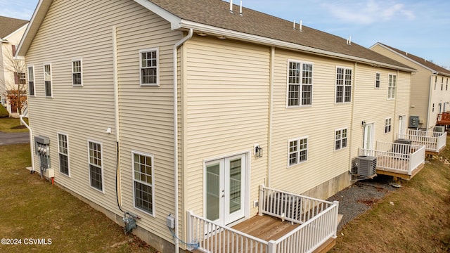 rear view of house featuring a deck and central air condition unit