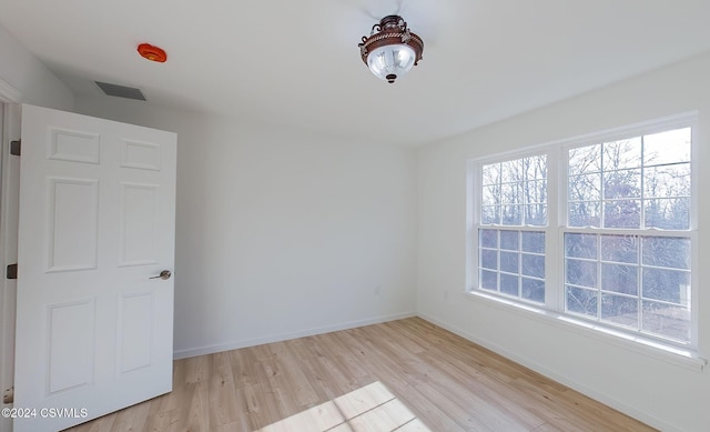 unfurnished room with light hardwood / wood-style flooring