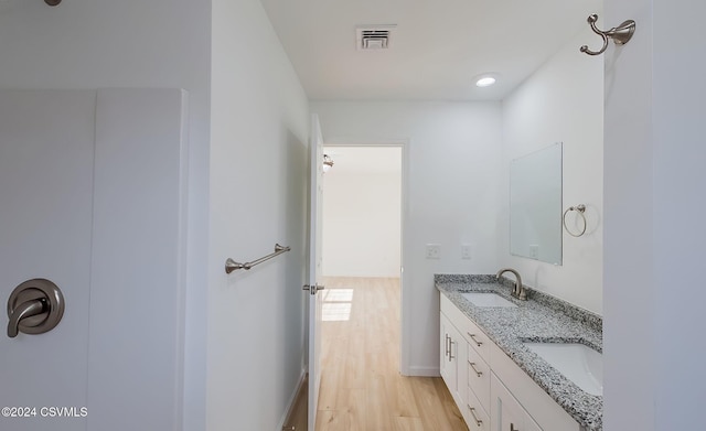 bathroom with hardwood / wood-style floors and vanity