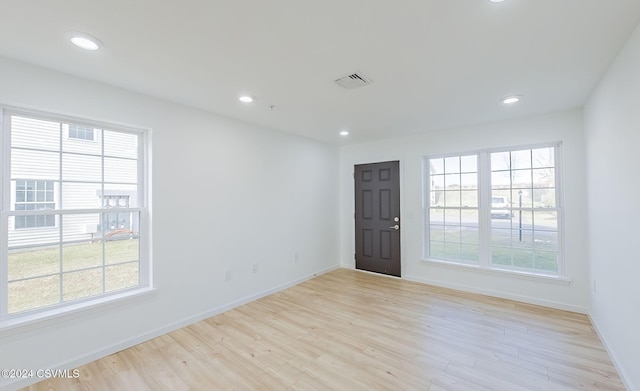 spare room with light hardwood / wood-style flooring