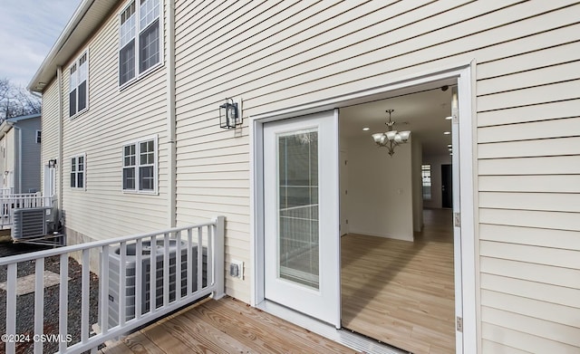 wooden deck featuring cooling unit