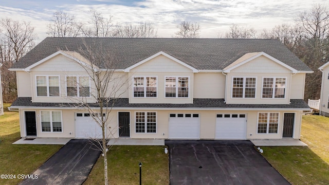 view of front of home featuring a garage and a front lawn