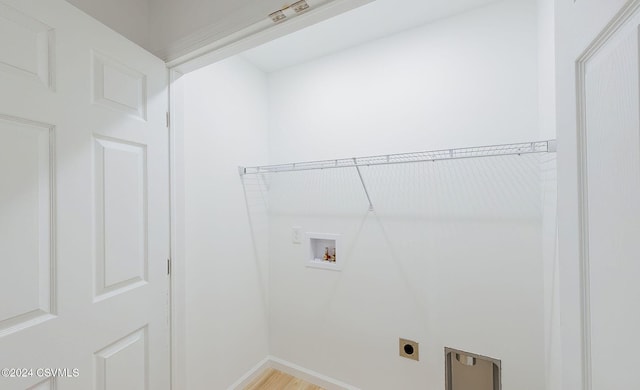 clothes washing area featuring electric dryer hookup, wood-type flooring, and hookup for a washing machine