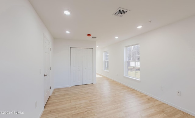 empty room with light hardwood / wood-style floors