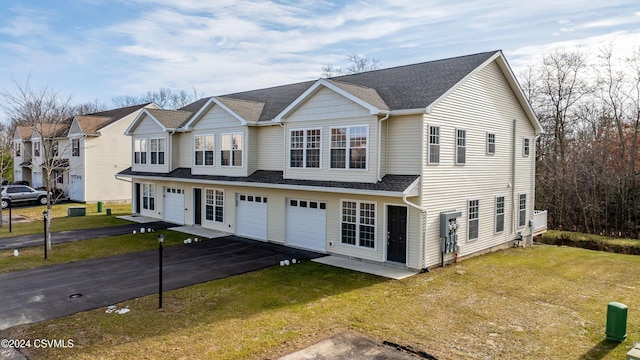 view of front of property with a front yard and a garage