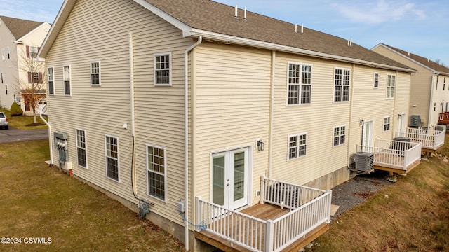 rear view of property with french doors, central AC, and a wooden deck