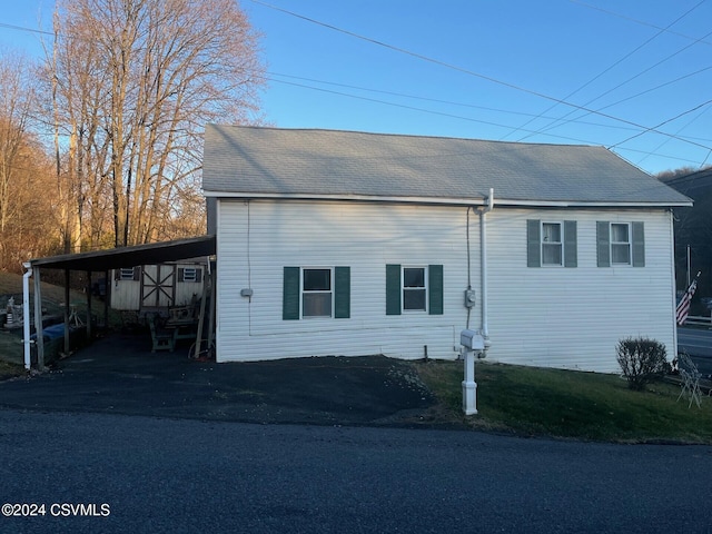 view of side of home with a carport