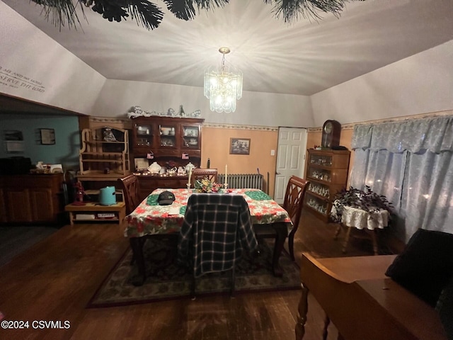 dining room with a chandelier, vaulted ceiling, and dark wood-type flooring