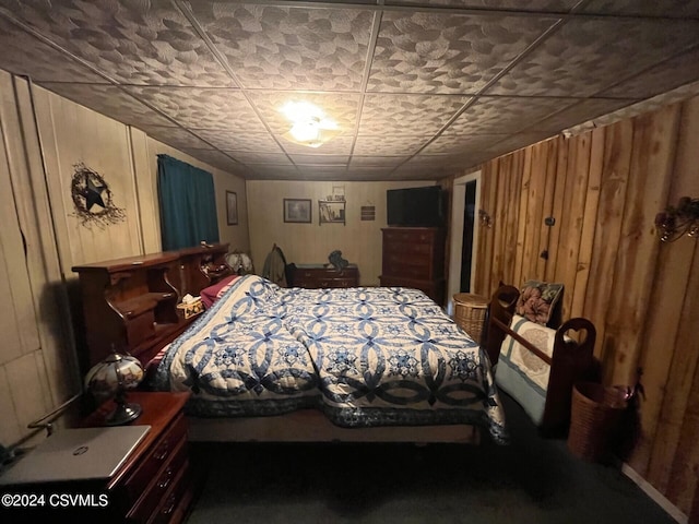 bedroom with wood walls