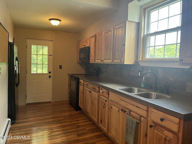 kitchen featuring dark wood-type flooring, a baseboard heating unit, black appliances, sink, and decorative backsplash