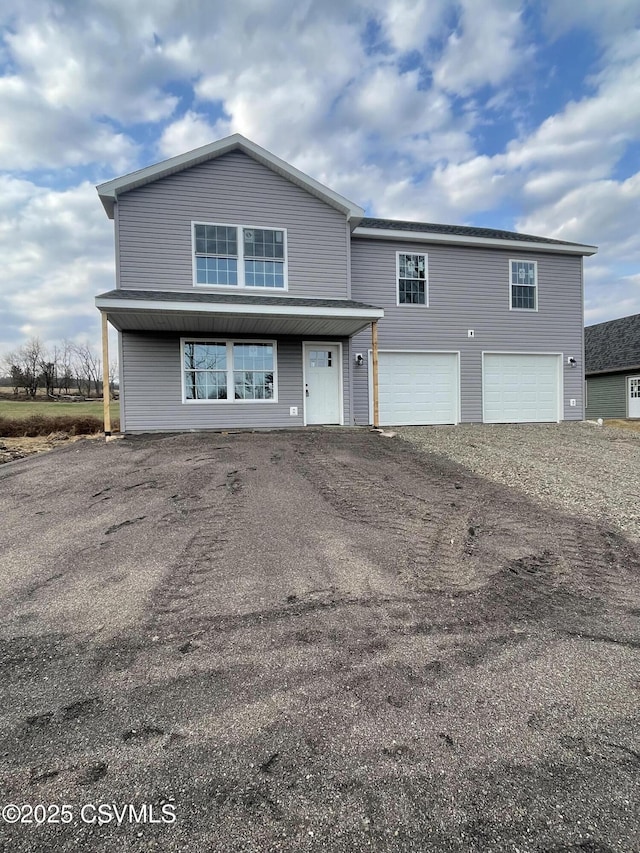 traditional-style home with an attached garage and driveway