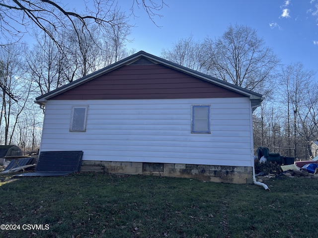 view of side of property with a yard