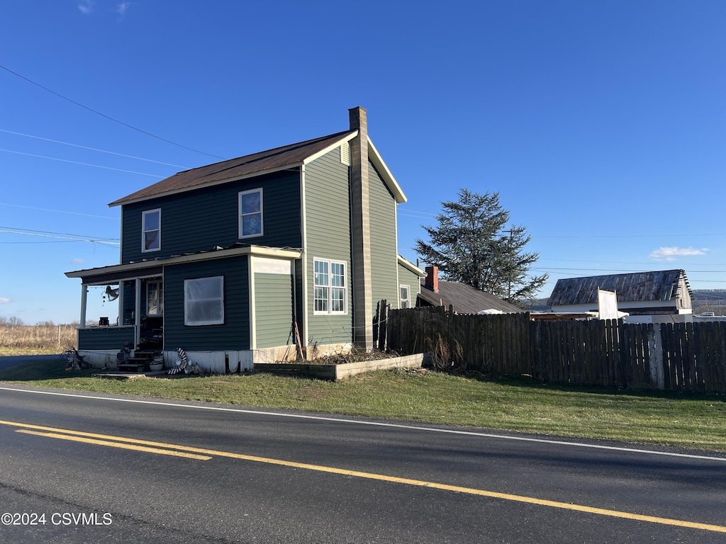 view of side of home featuring a yard