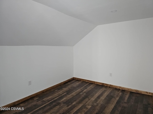 bonus room featuring dark wood-type flooring and lofted ceiling