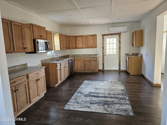 kitchen with coffered ceiling, an AC wall unit, sink, appliances with stainless steel finishes, and dark hardwood / wood-style flooring