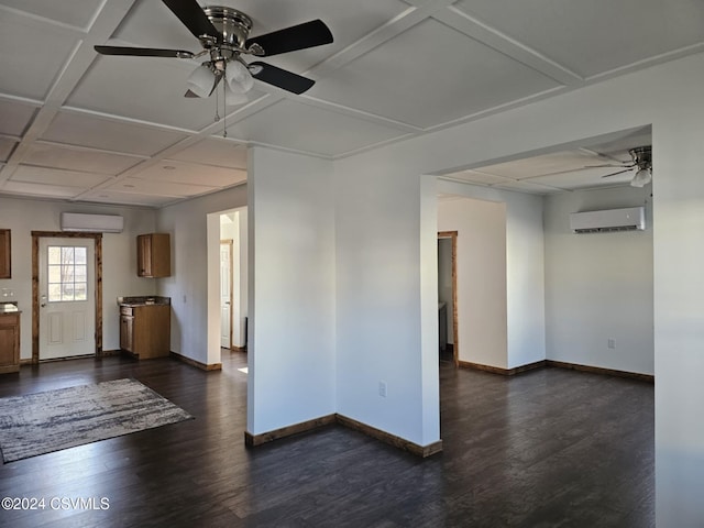 empty room featuring ceiling fan, coffered ceiling, dark hardwood / wood-style floors, and a wall mounted air conditioner