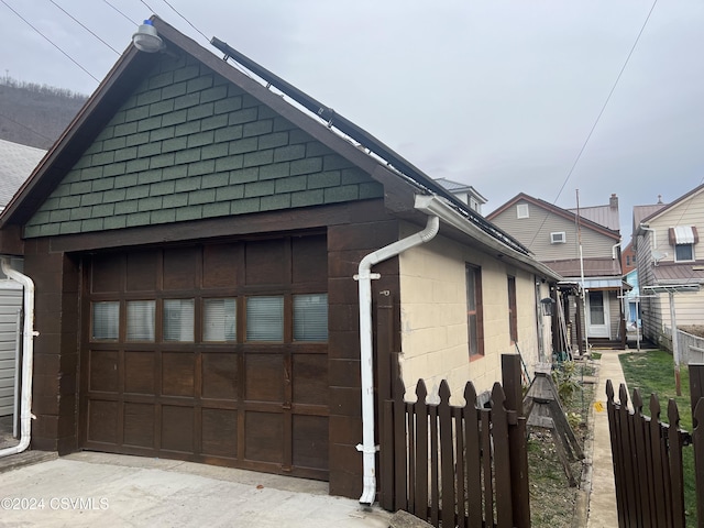 view of side of home featuring a garage