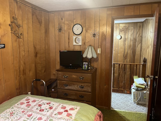 carpeted bedroom with wooden walls