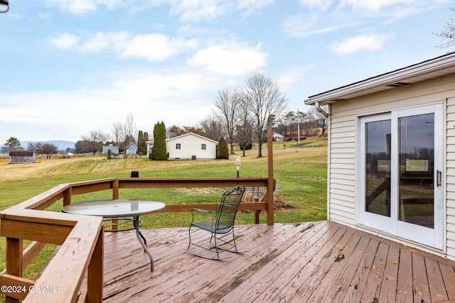 wooden terrace featuring a yard